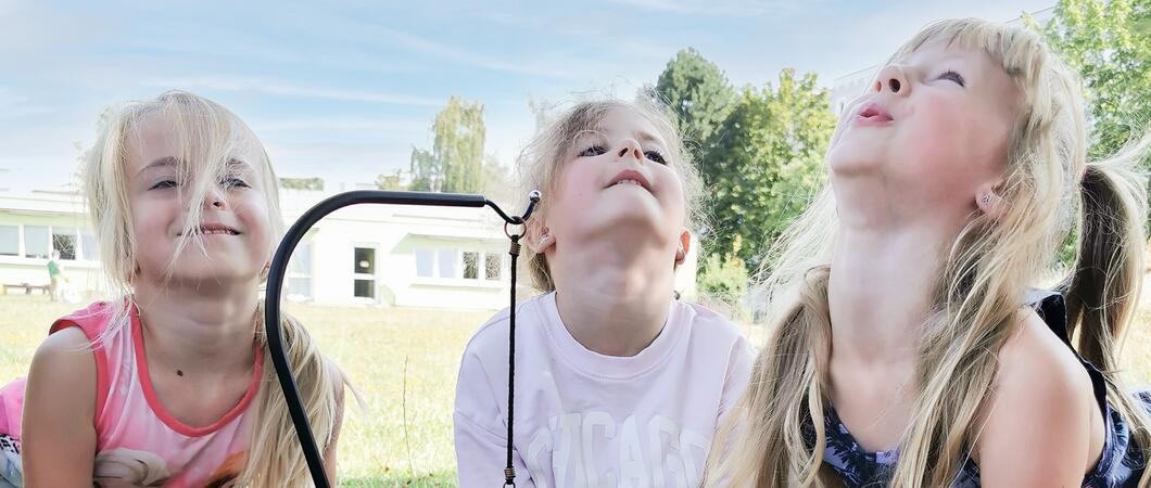 Drinnen flitzen einige Kinder über die Spielflure oder testen ihr Geschick an einer Klangschale mit Wasser. Draußen haben sich Elay, Justus und Egon einen Pferdestall aus Kisten gebaut.